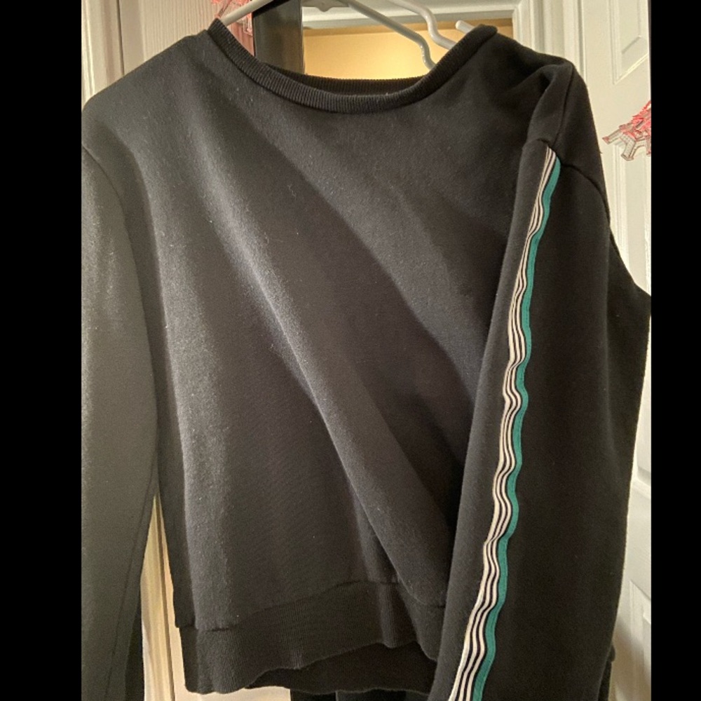 A black sweater with green and white stripes